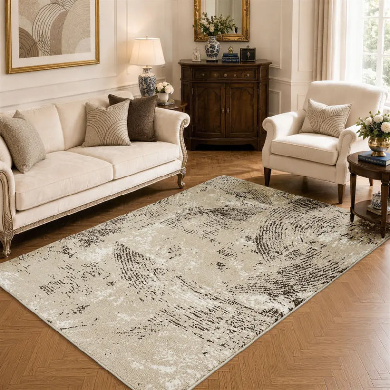 Living room with a oatmeal & espresso patterned rug, sofa, and armchair.