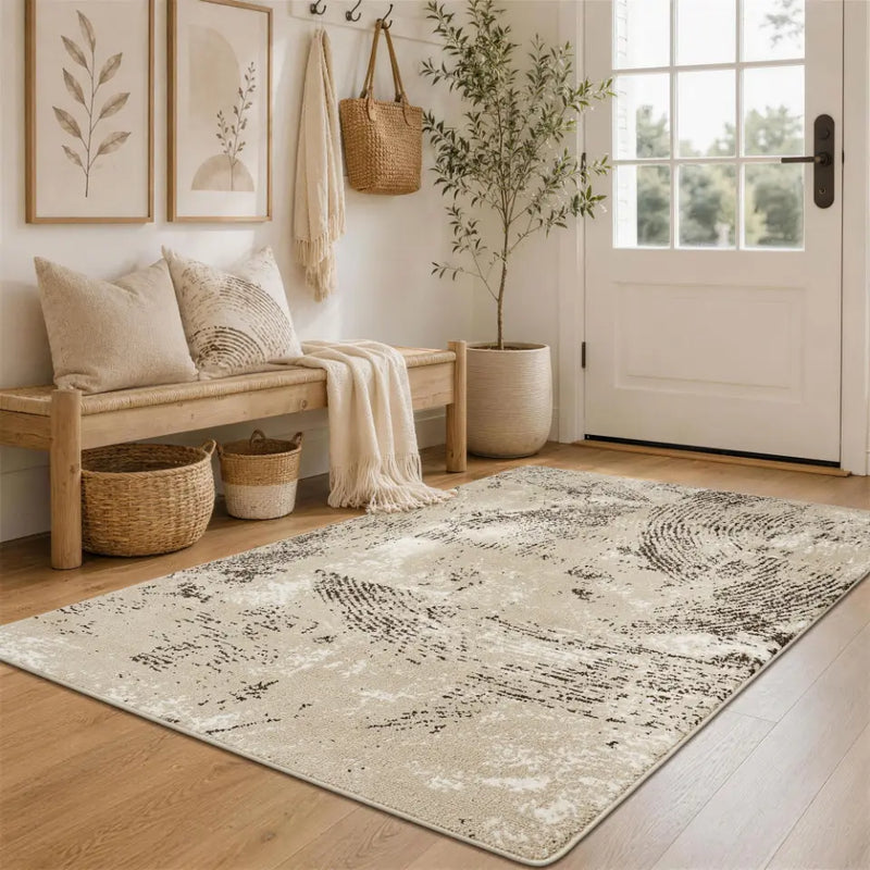 Nestled entryway with a oatmeal & espresso patterned rug, bench, and coat rack.