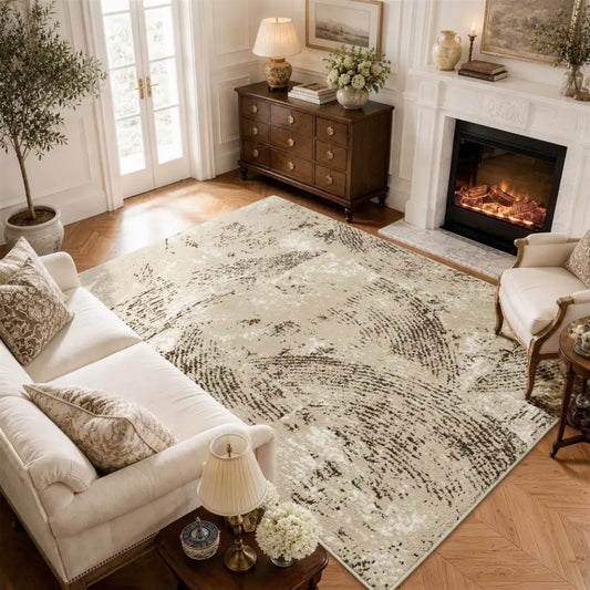 Living room with a large oatmeal & espresso patterned rug, sofa, and fireplace.