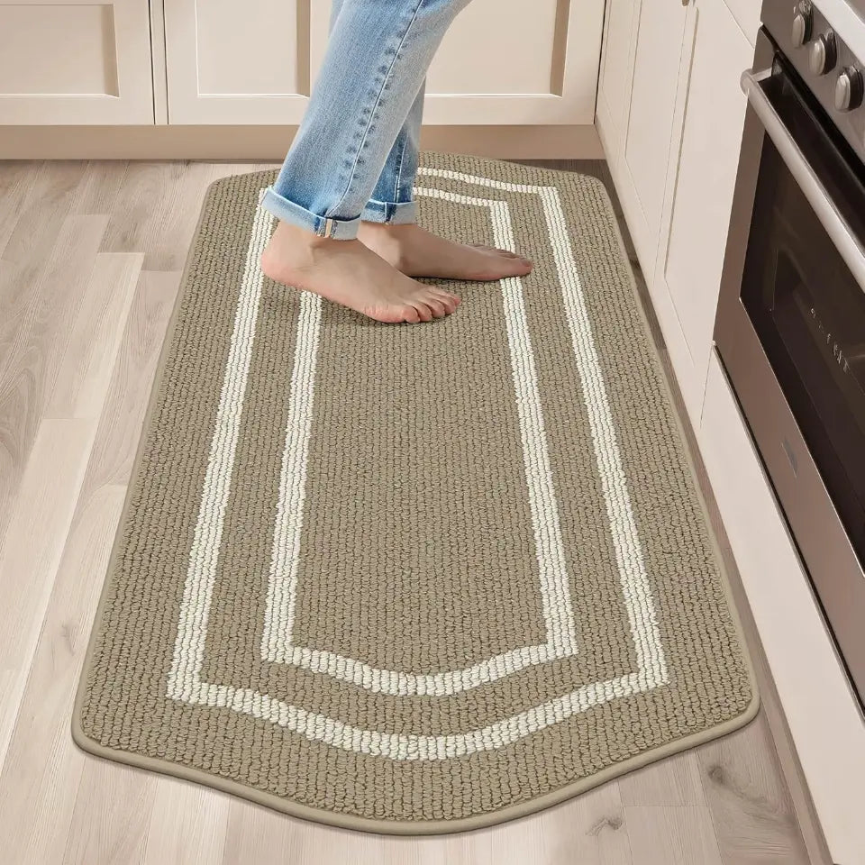 Person stepping onto a textured rug with a geometric pattern in a kitchen.