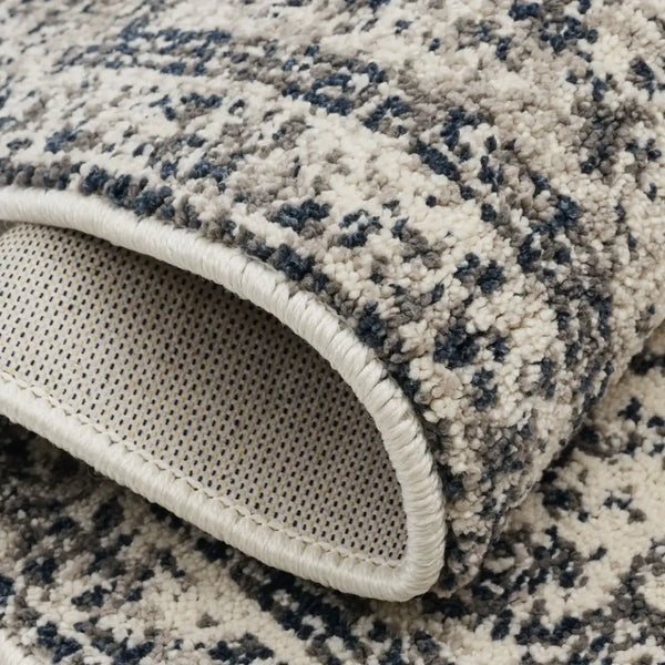 Close-up of a textured rug with a patterned edge