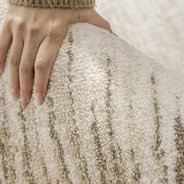 Beige textured rug on a wooden floor