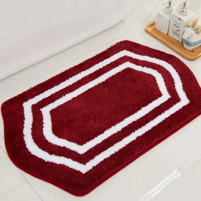 Red bath mat with white border on a bathroom floor