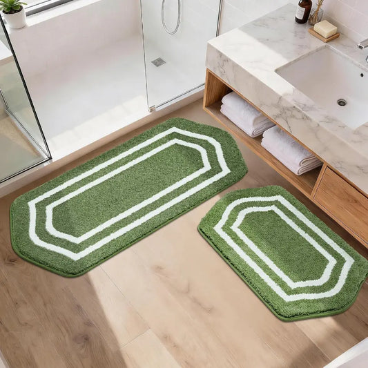 Green bath mats with white borders on a bathroom floor.