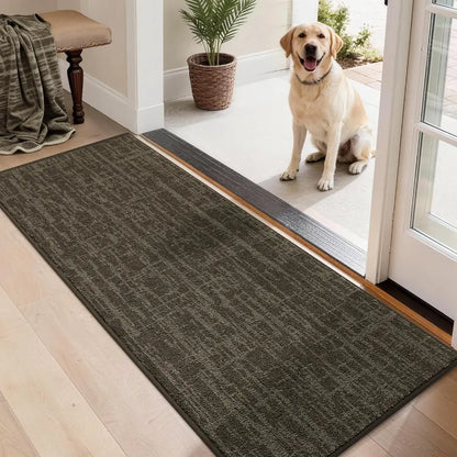 Dog standing on a brown doormat at the entrance of a home