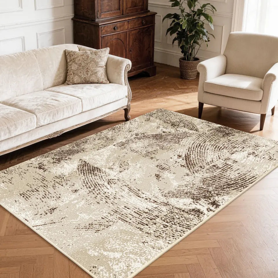 Living room with a oatmeal & espresso patterned rug, sofa, and armchair.