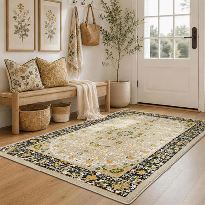 Decorative gold & charcoal rug with floral pattern in a home entryway.