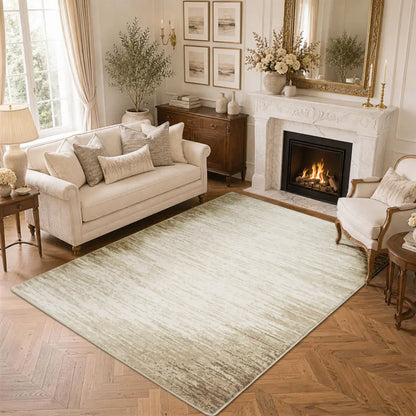 Living room with a large taupe & cream gradient area rug, white sofa, and armchair.