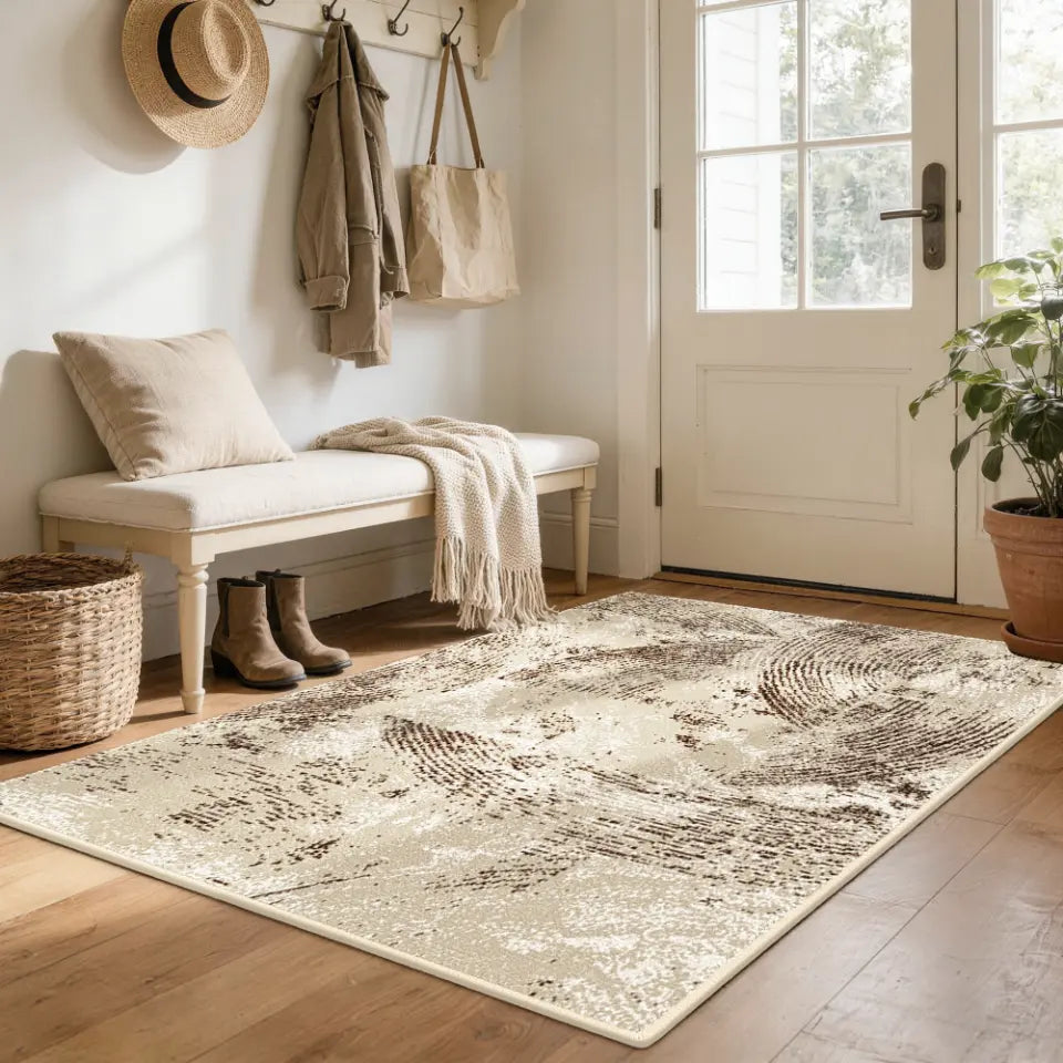 Nestled entryway with a oatmeal & espresso patterned rug, bench, and coat rack.