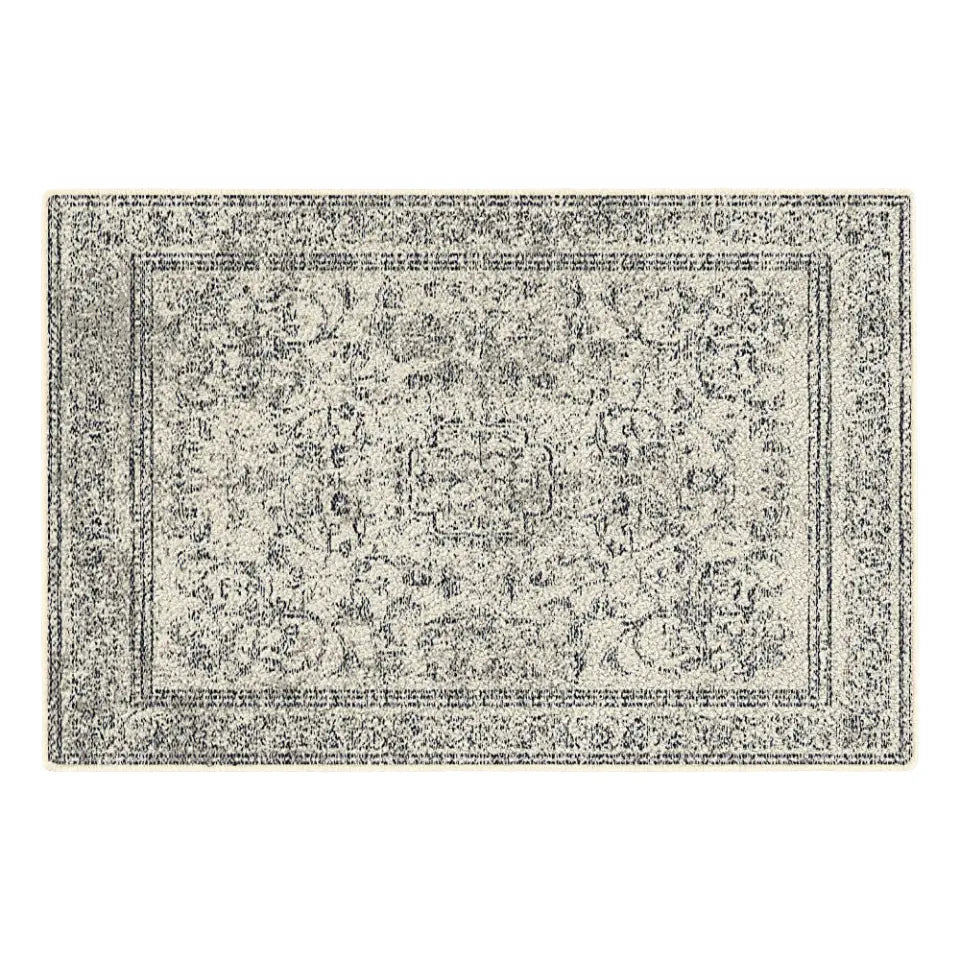 Grey and white patterned rug on a white background