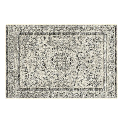 Grey and white patterned rug on a white background