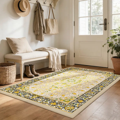 Decorative gold & charcoal rug with floral pattern in a home entryway.
