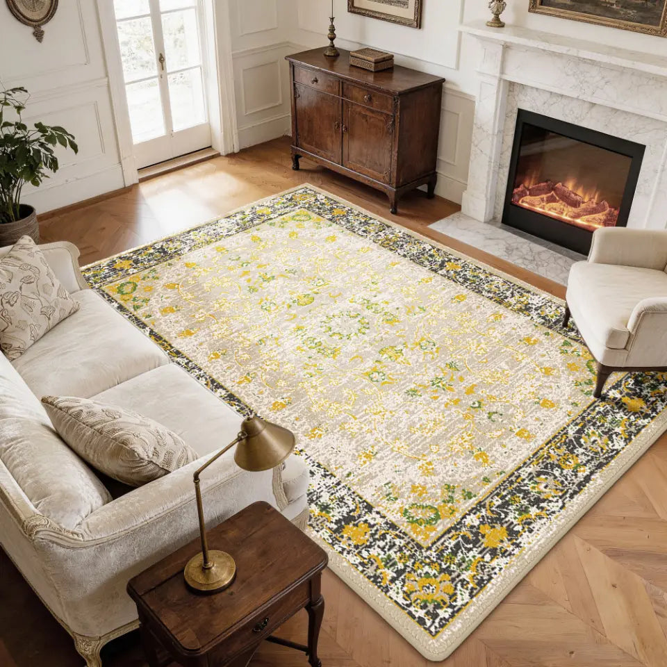 Living room with a gold & charcoal floral-patterned cozy area rug, sofa, and fireplace.