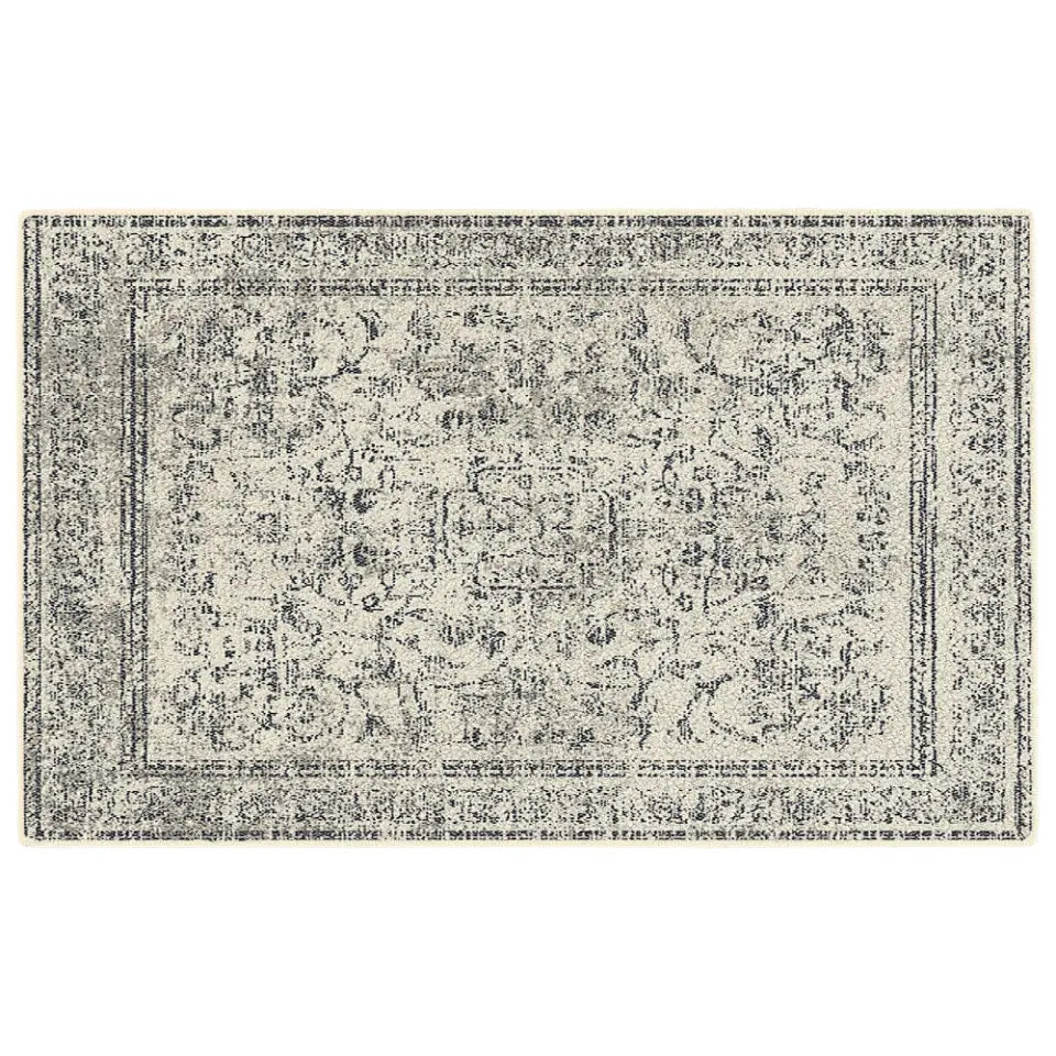 Grey and white patterned rug on a white background