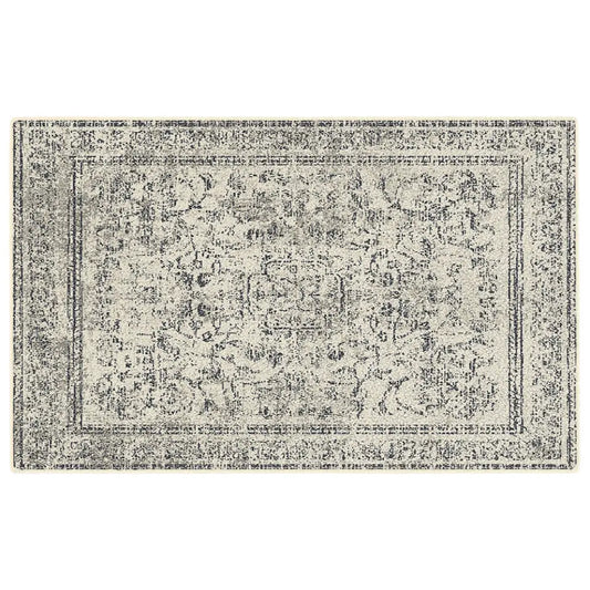 Grey and white patterned rug on a white background