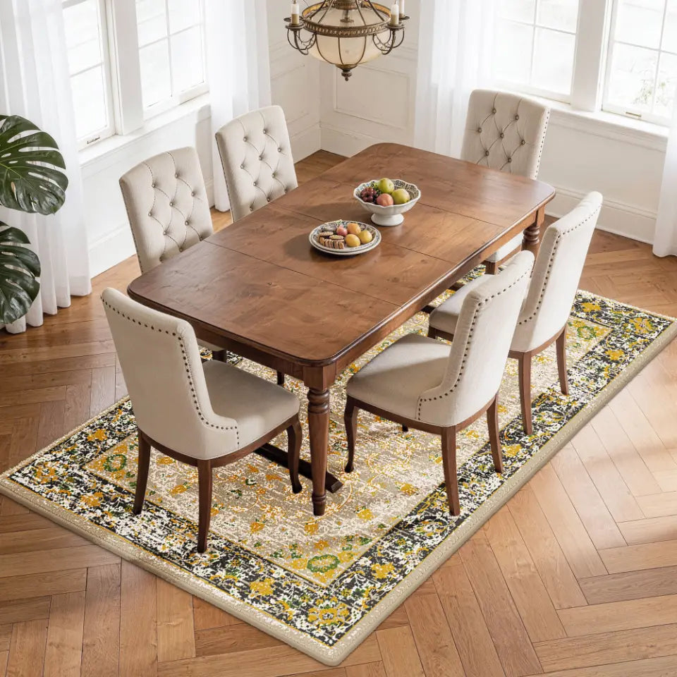 Dining room with wooden table and chairs on a gold & charcoal patterned rug