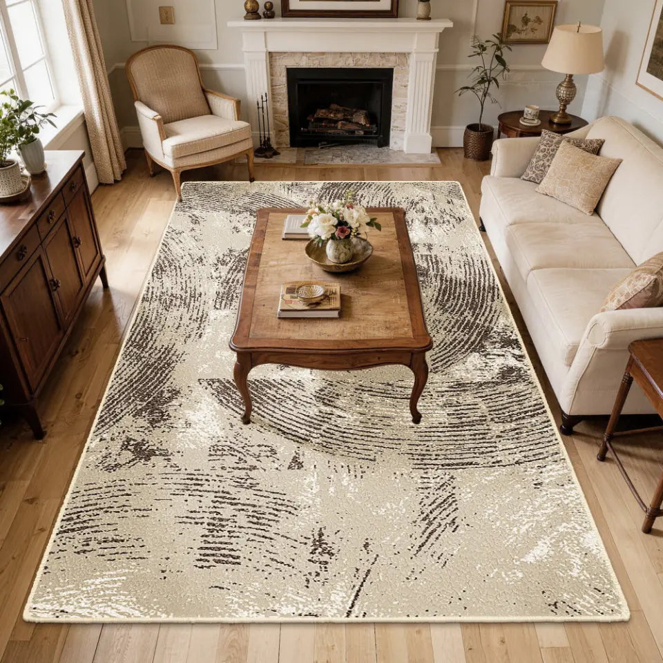 Living room with a large oatmeal & espresso patterned rug, wooden coffee table, and beige sofa.