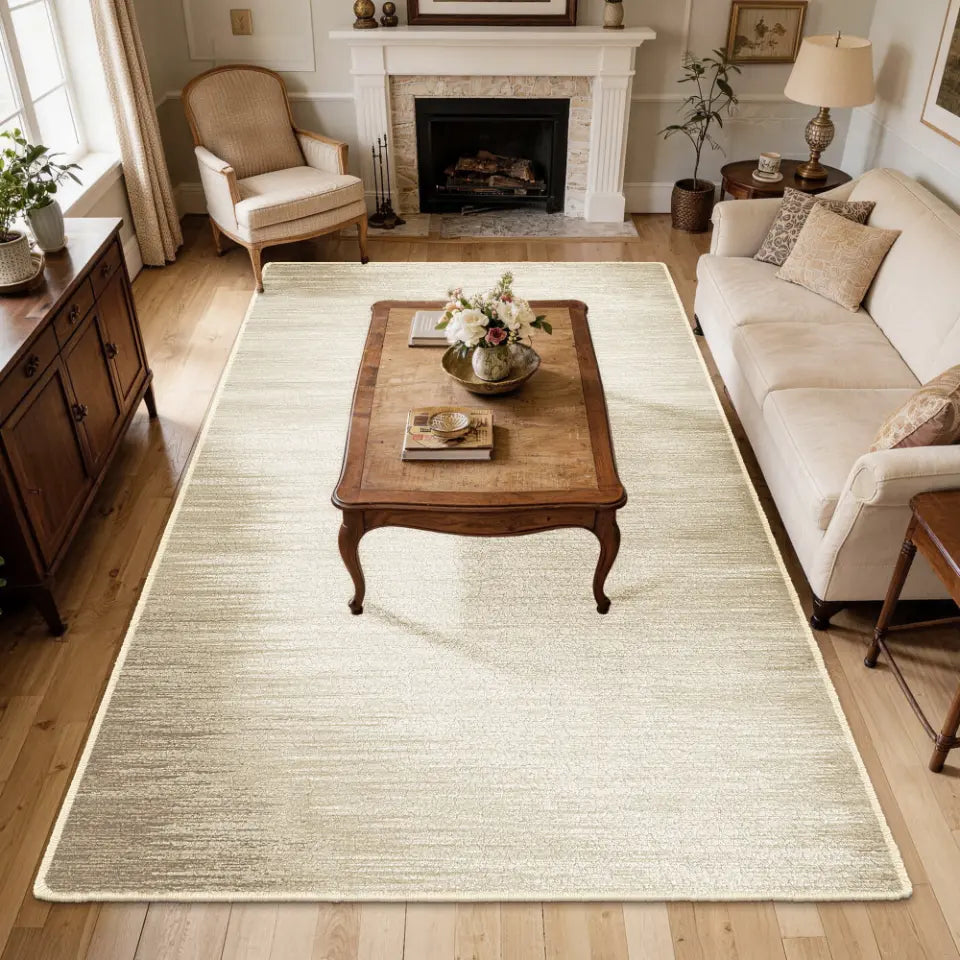 Living room with a large taupe & cream gradient area rug, wooden coffee table, and beige sofa.