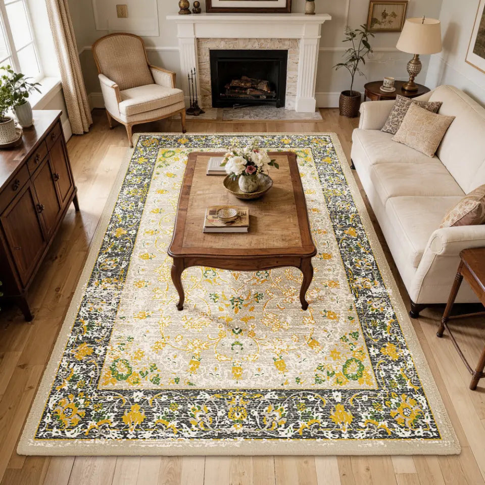 Living room with a floral gold & charcoal patterned rug, sofa, and coffee table.