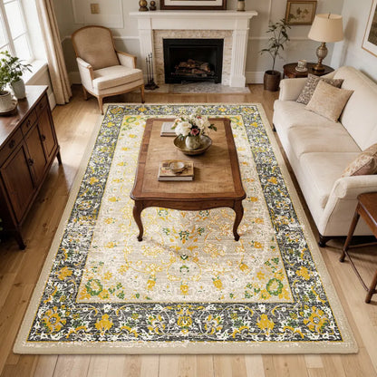 Living room with a floral gold & charcoal patterned rug, sofa, and coffee table.