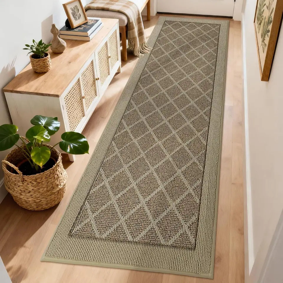 Patterned beige rug on a wooden floor with a plant and cabinet in the background