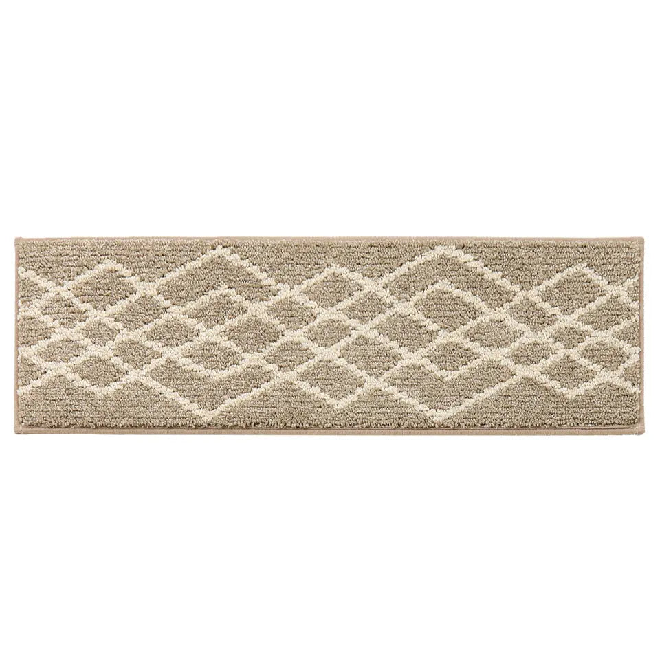 Beige and white geometric patterned stair rug on a white background