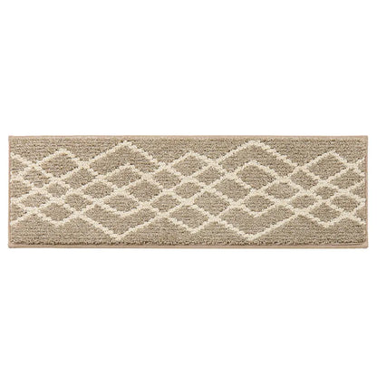 Beige and white geometric patterned stair rug on a white background