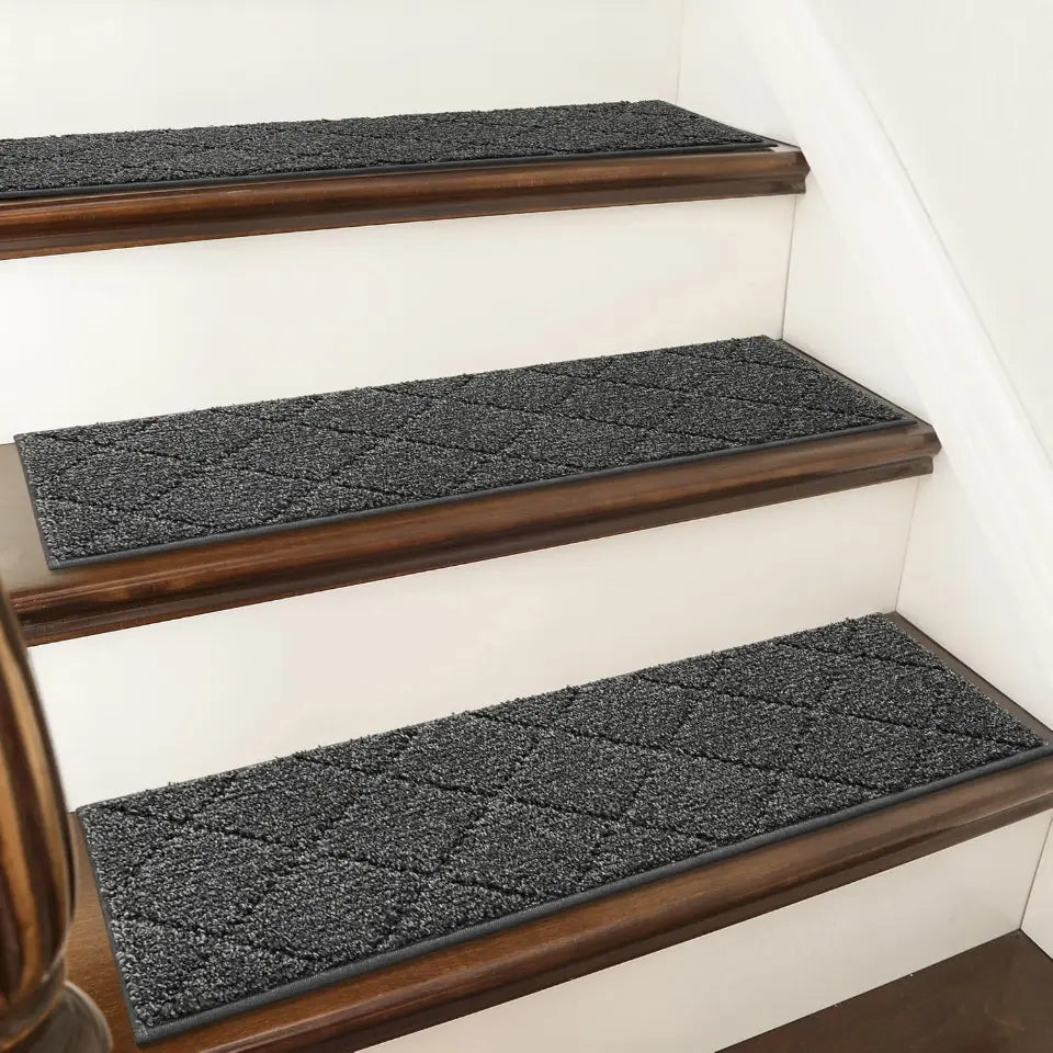 Black textured stair treads on wooden stairs with a white wall background