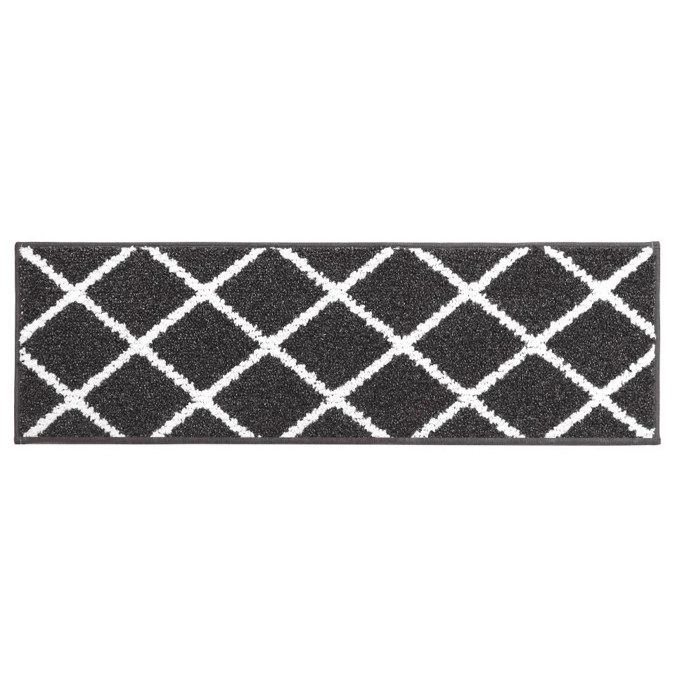 Black stair mat with white geometric pattern on a white background