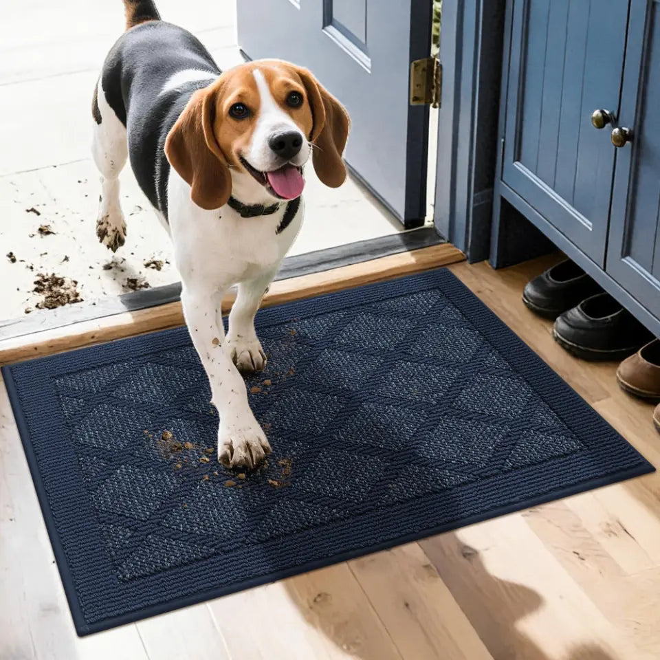Dog stepping onto a blue doormat with mud on its paws, inside a house.