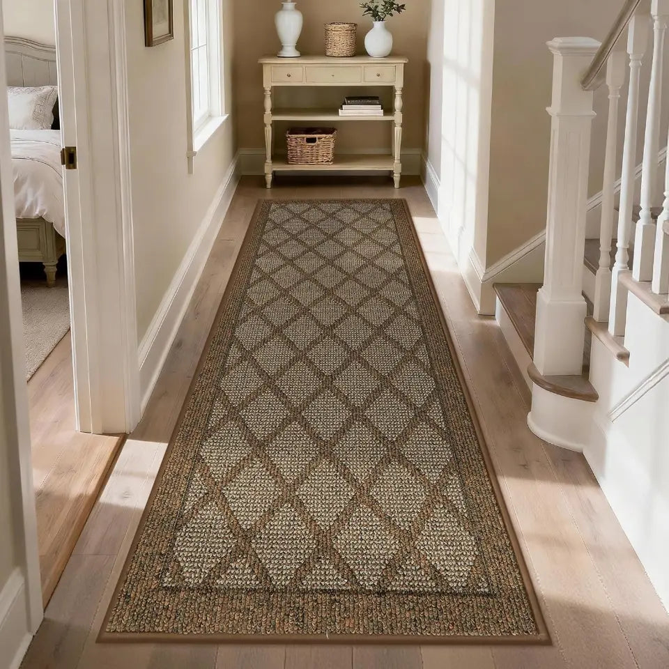 Patterned light brown rug on a wooden floor in a home setting with a staircase and furniture.