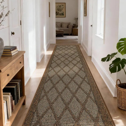 Long, patterned light brown rug in a hallway with wooden furniture and decor.