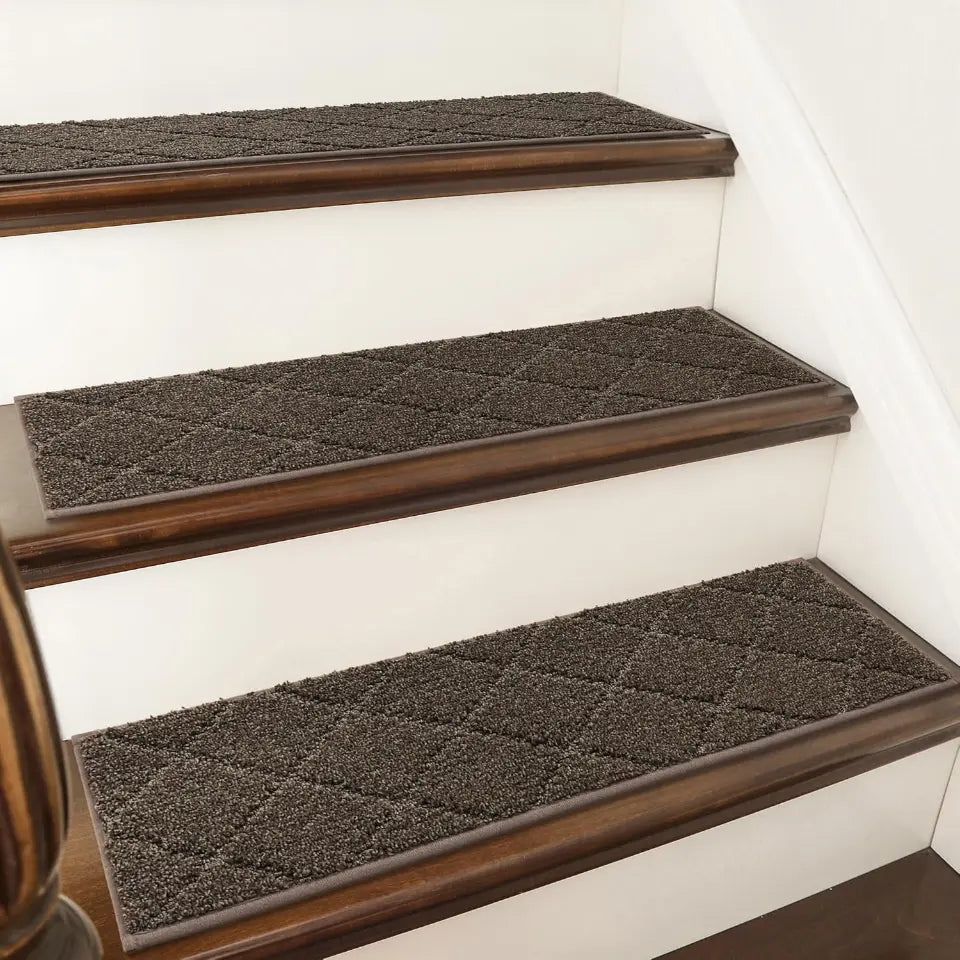 Brown stair treads with diamond pattern on wooden stairs