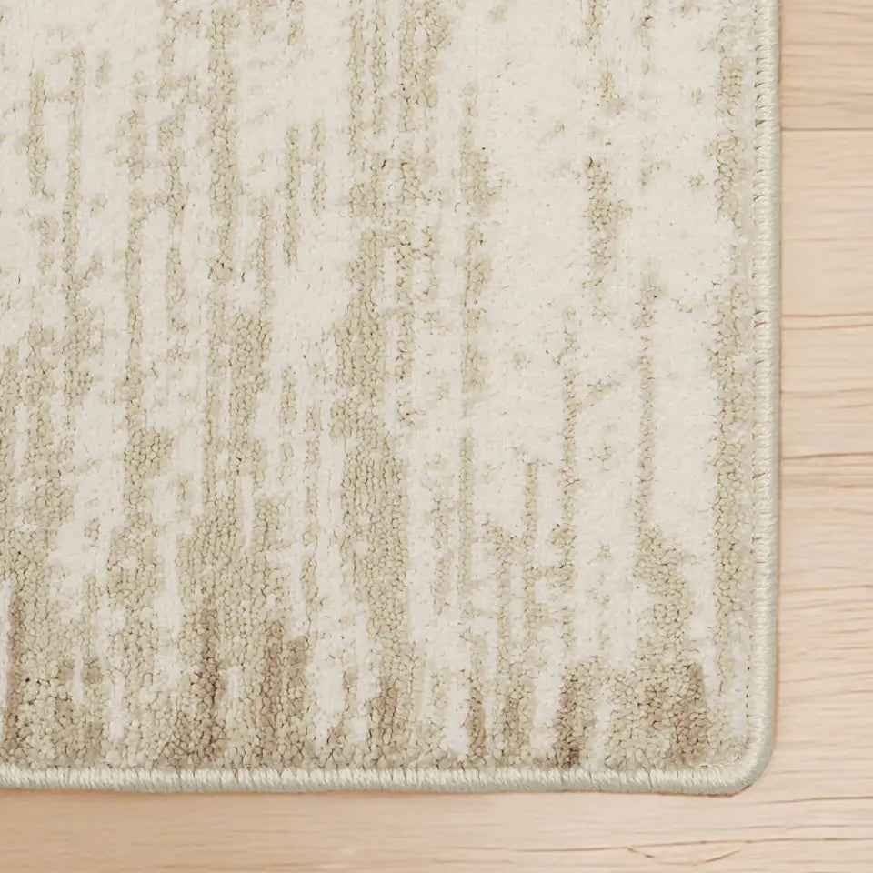 Textured beige rug on a wooden floor