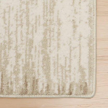 Textured beige rug on a wooden floor