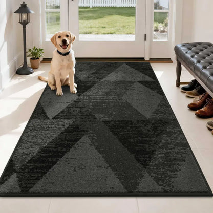 Dog sitting on a dark grey geometric patterned rug in a modern living room.