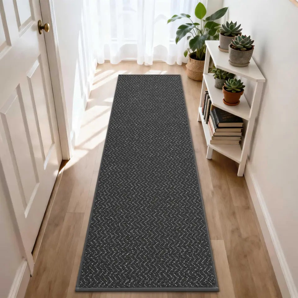 Long dark grey rug on a wooden floor with a white door and bookshelf in the background.