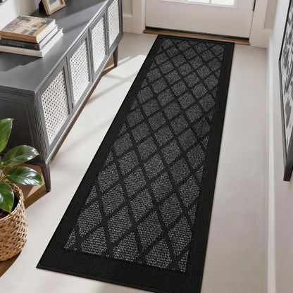 Dark grey patterned rug on a light wood floor in a room with a console table and plant.