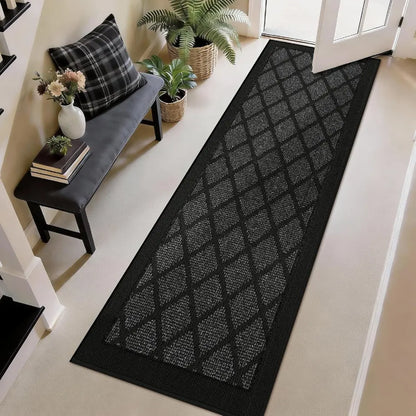 Dark grey diamond-patterned rug on a light wood floor with a bench and plants in the background.