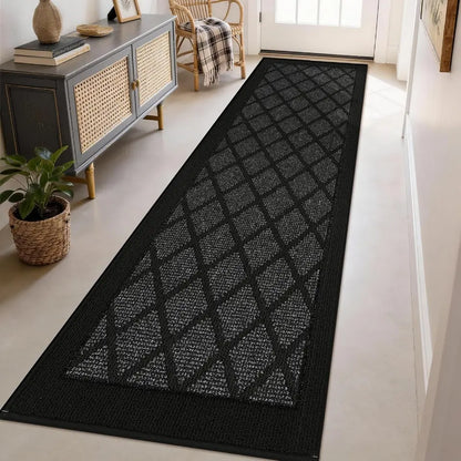 Dark grey geometric patterned rug on a light wooden floor in a room with furniture.