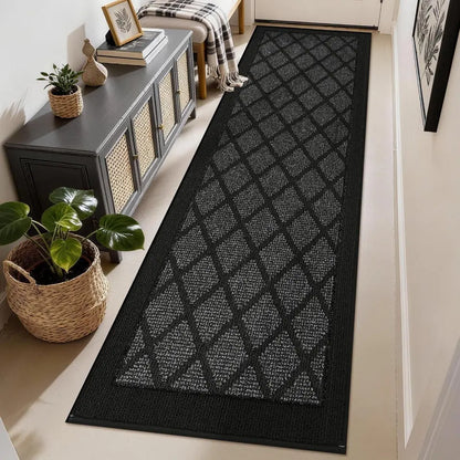 Dark grey geometric patterned rug on a light wood floor in a home setting.