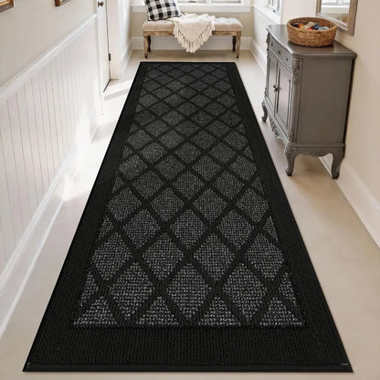 Dark grey geometric patterned rug on a light wood floor in a home setting.