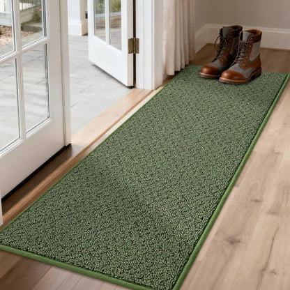 Green doormat in front of a glass door with shoes on it