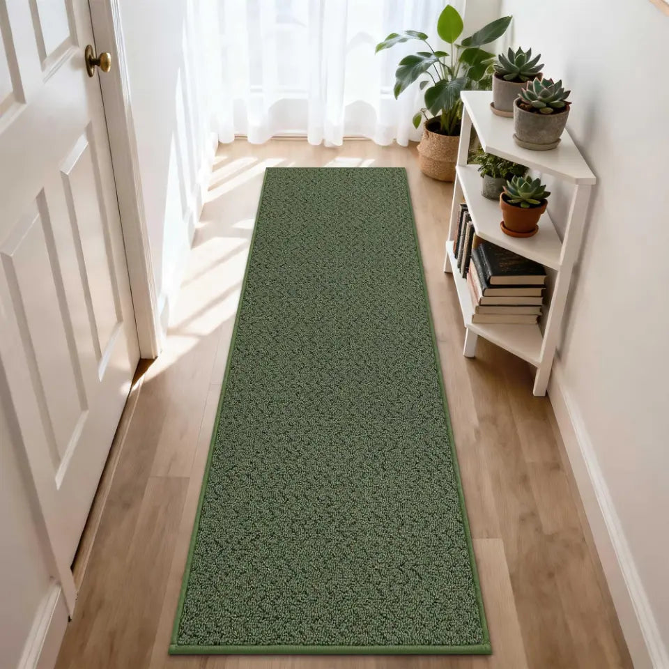 Green runner rug on a wooden floor with a white door and bookshelf in the background.