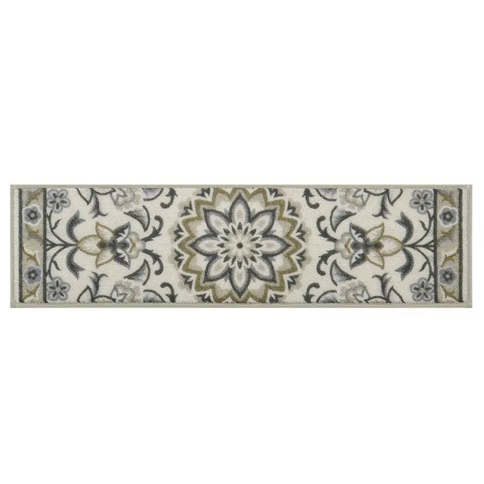 Decorative grey/green floral rug with a white background
