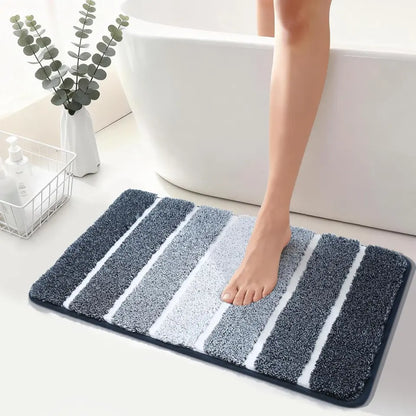 High Contrast dark blue striped bath mat with a person stepping onto it in a bathroom setting.