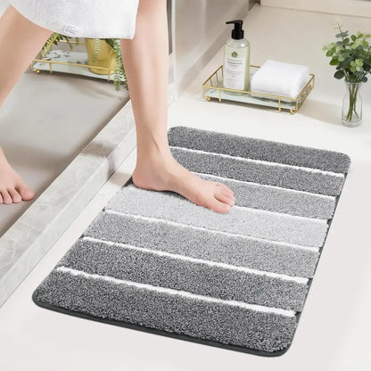 High Contrast grey and white striped bath mat on a bathroom floor with a person stepping onto it.