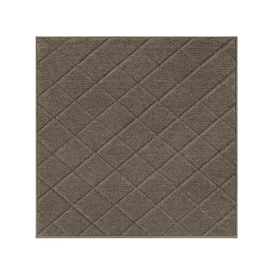 Textured light brown diamond patterned stair corner mat on a white background