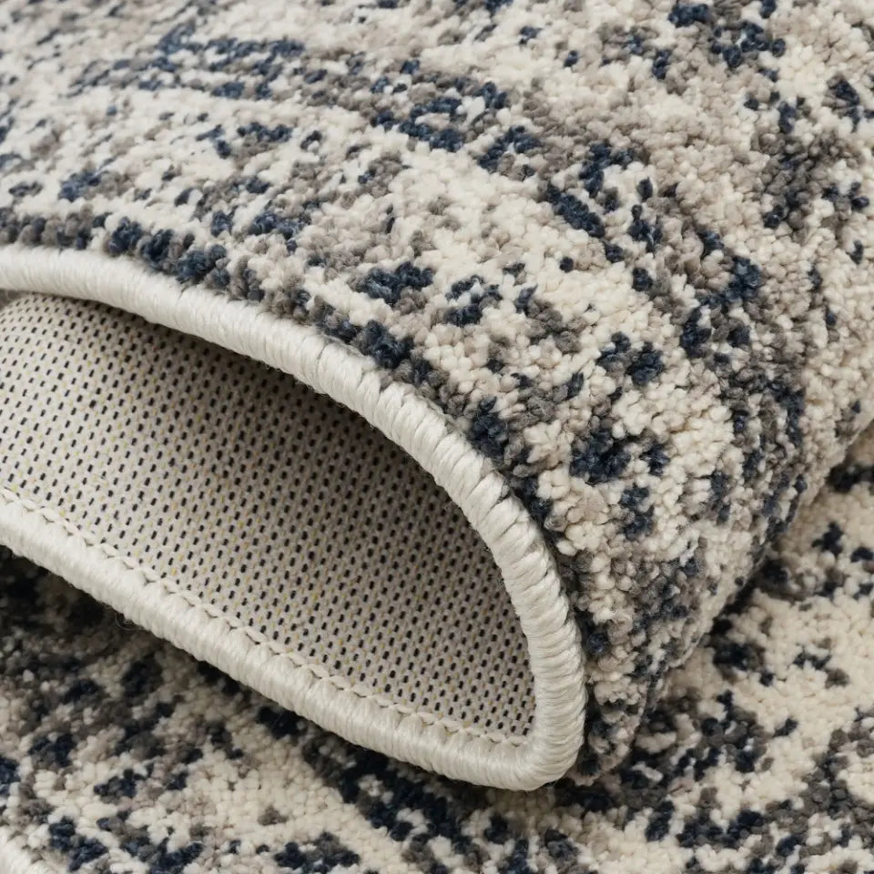 Close-up of a textured rug with a patterned edge