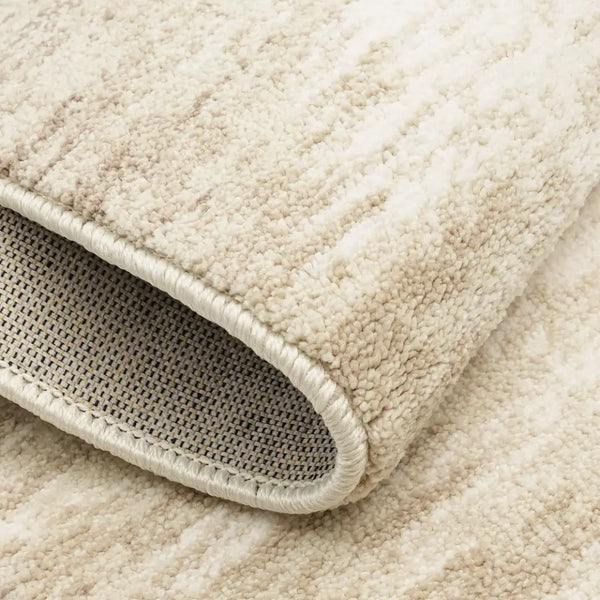 Close-up of a beige textured rug with a woven pattern